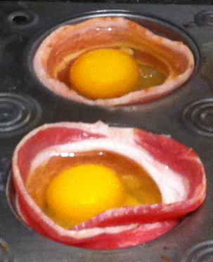 Egg bake preparations - bacon wrapped around cupcake cup with egg